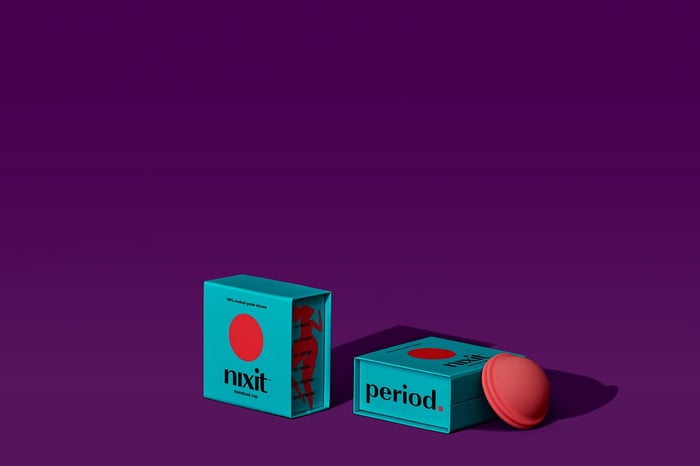 two nixit boxes and one menstrual disc leaning on one of the boxes