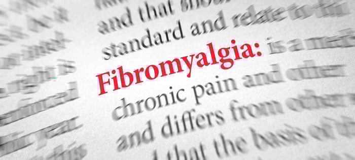 Close up of blurred photo of dictionary definition of fibromyalgia