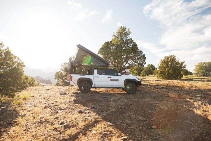 The Alu-Cab ModCAP Tailgate truck camper with the tent top fully deployed.