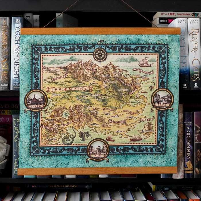An Ember in the Ashes Map hangs from a wood frame showing The Empire from Sabaa Tahir's book