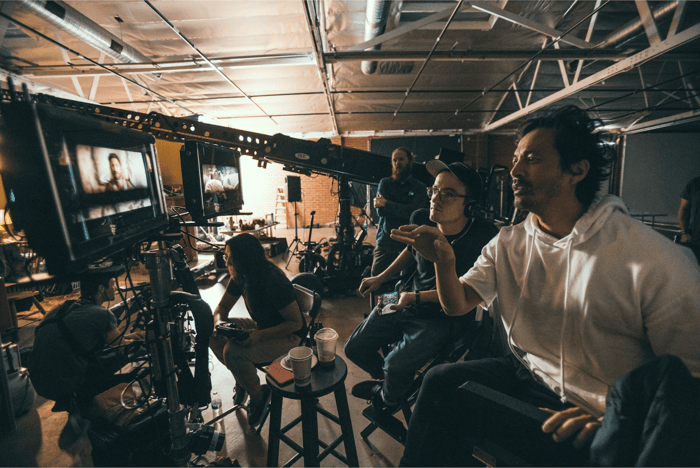 Gabe Harden checking frames with Director Yu Tsai on set for a music video for Jordan McGraw