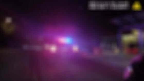 Blurred police emergency lights at night, representing the redaction labor behind police video records requests