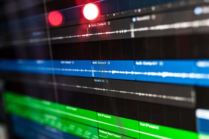 Close up of an editing timeline with audio waveforms, representing the audio redaction process