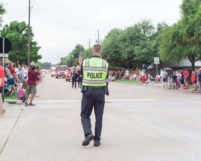Police officer on duty at a public event, representing body worn camera footage subject to records requests