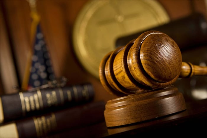 Gavel resting on law books, representing why early forensic expert involvement matters before trial
