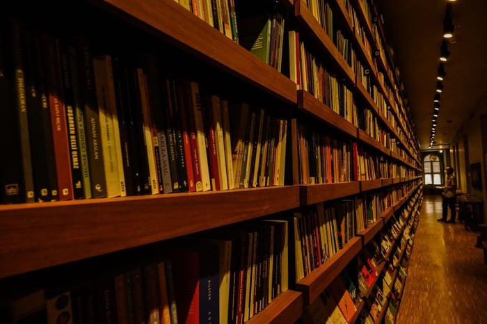 Long shelves of bound legal volumes in a law library, representing the FERPA and state records law research behind school surveillance video redaction decisions