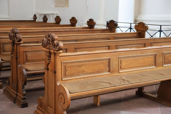 Rows of polished wooden courtroom seating representing the legislative and judicial processes shaping new body camera redaction laws