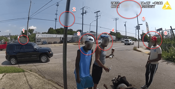 Body worn camera frame with numbered circles marking faces and license plates a redaction mask must cover