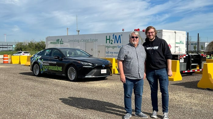 Father and son with a Mirai in the Prairies
