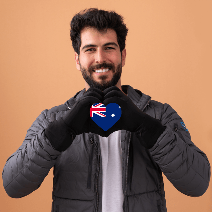 Man with an Australian flag in his hands as he makes a heart shape