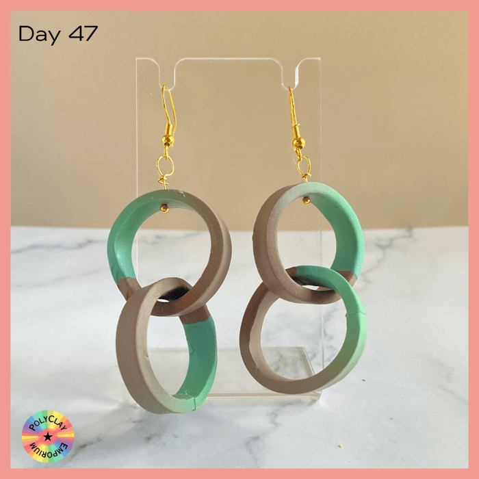 Double hoop polymer clay earrings, made from a green to brown skinner blend.