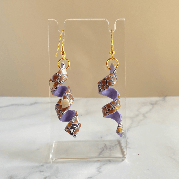 A beautiful pair of spiral polymer clay earrings with lavender colored lining