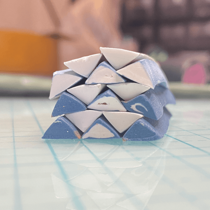 Stack of blue and white triangular canes.