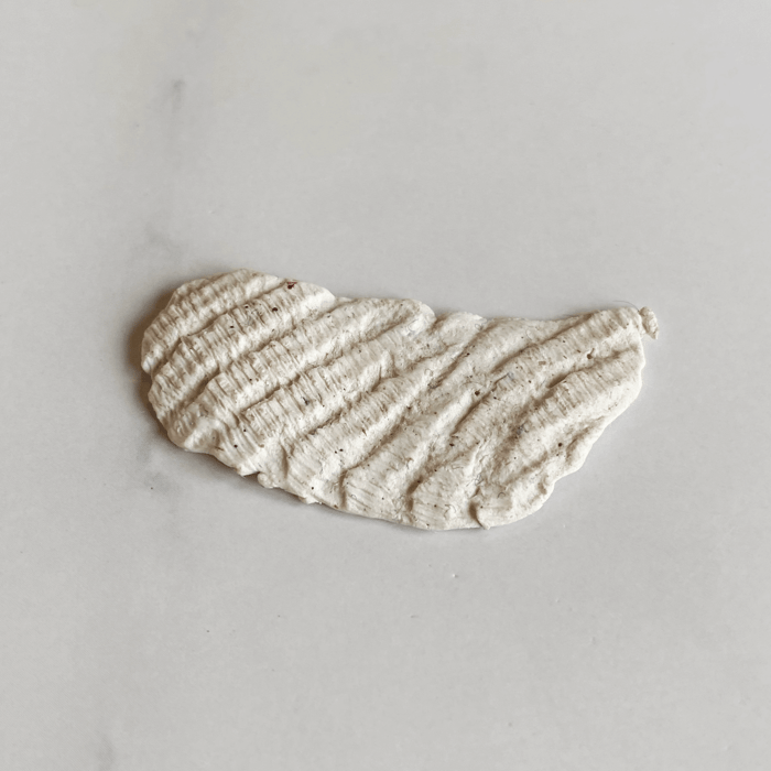 Scrap of polymer clay with texture resembling a weathered scallop shell