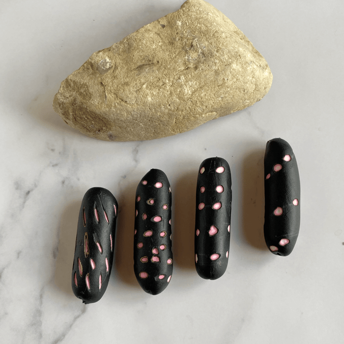 Some carved polymer clay cylindar beads