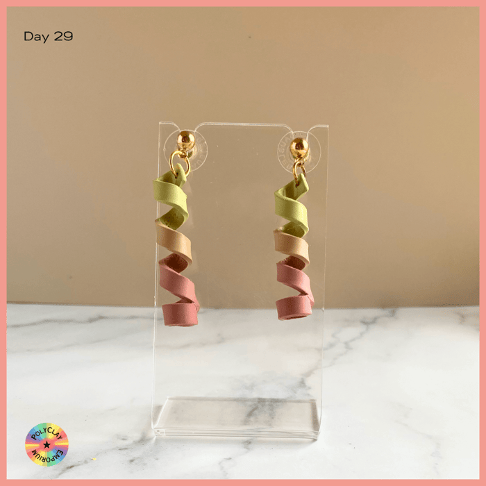 Olive to terracotta polymer clay spirals as earrings.