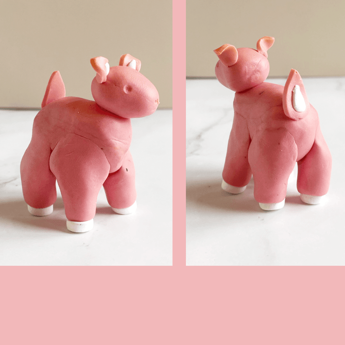 A misshapen pink polymer clay deer with adorable white hooves and accents on tail and ears