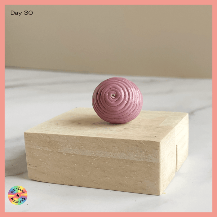 Swirled extruded polymer clay 'spaghetti' on this bead.