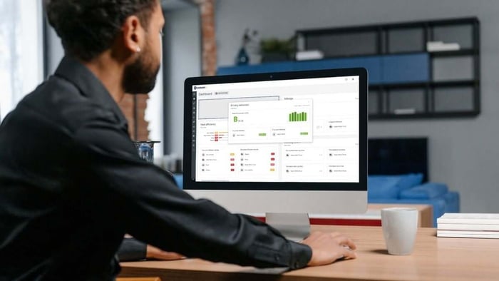 Man looking at Trackem GPS dashboard information tracking fleet from office