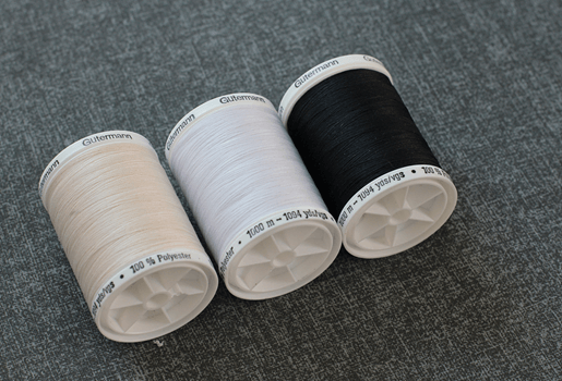 A group of spools of threadAI-generated content may be incorrect.