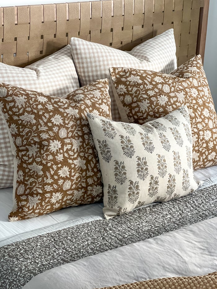 Bed made with block print cushions and quilt.