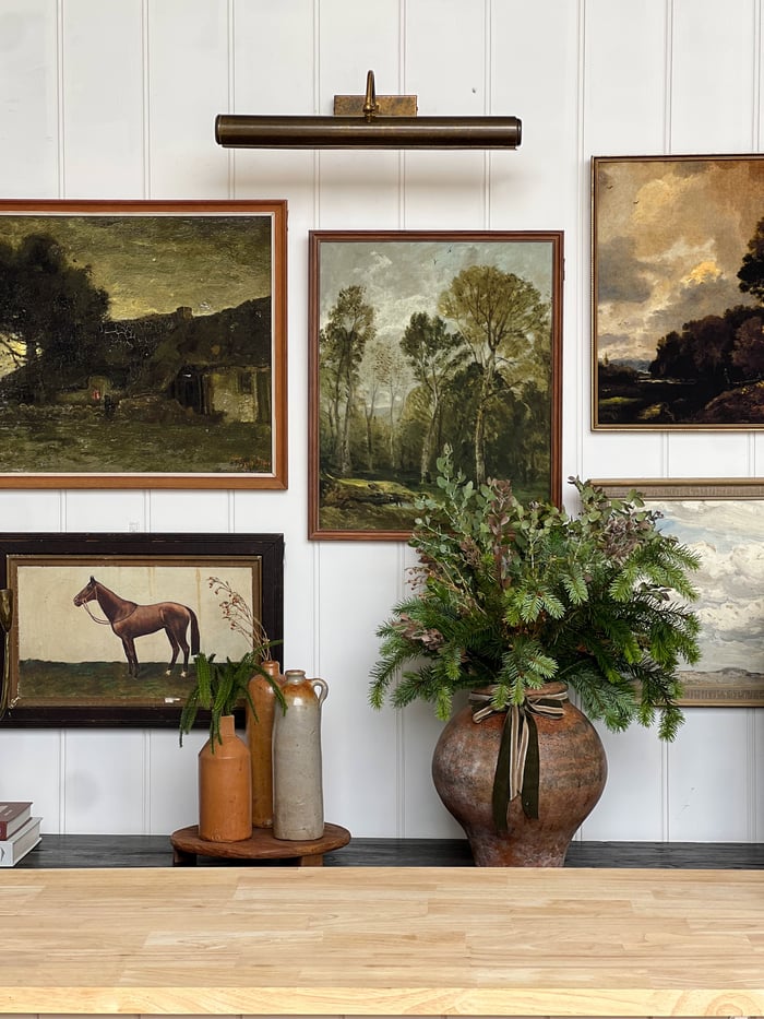 Artwork gallery with brass picture light.