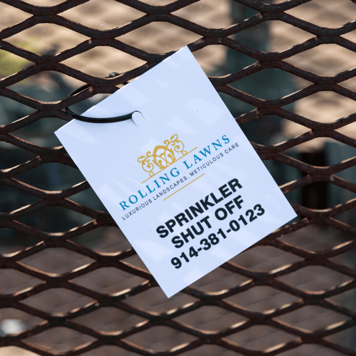 sprinkler shut-off tag zip-tied to a metal grate