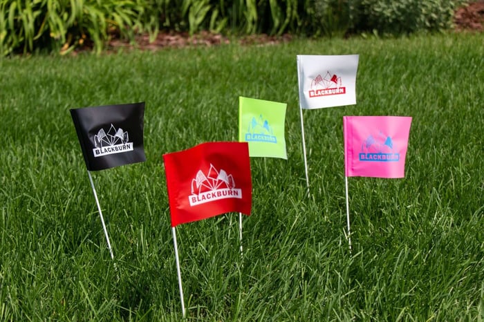 vinyl marking flags printed with Blackburn's logo in the grass