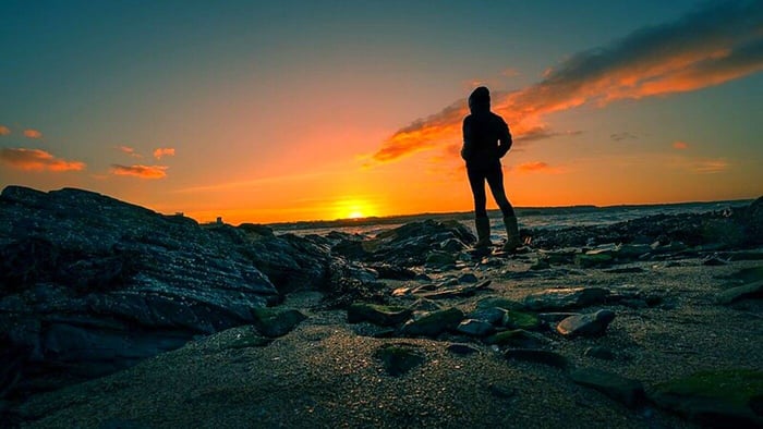 A man practices mindfulness by the ocean.