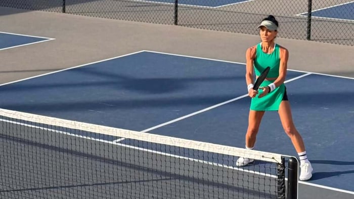 Adriana positioned on a pickleball court