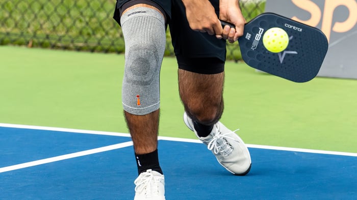 Close up shot of a pickleball connecting with the racket on a return