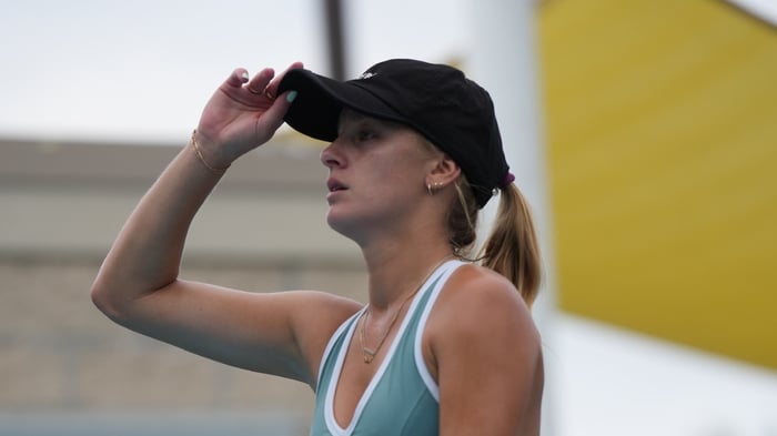 Pickleball player in a match holding her cap