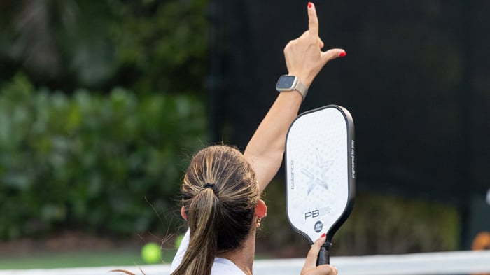 Woman counting score in pickleball game