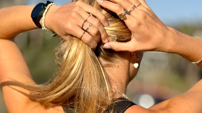Woman tying her hair after pickleball match