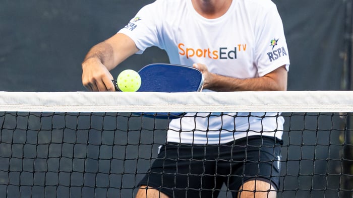 Pickleball player returning a shot