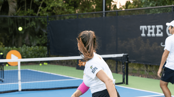 Players on a court playing pickleball