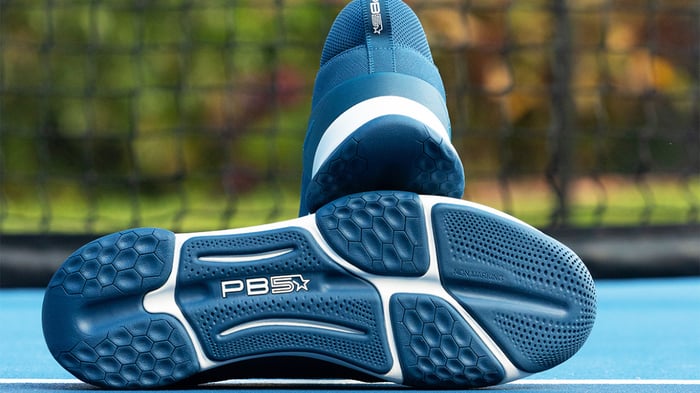 A pair of pickleball shoes on a court