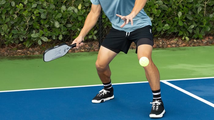 Man preparing to hit a pickleball shot