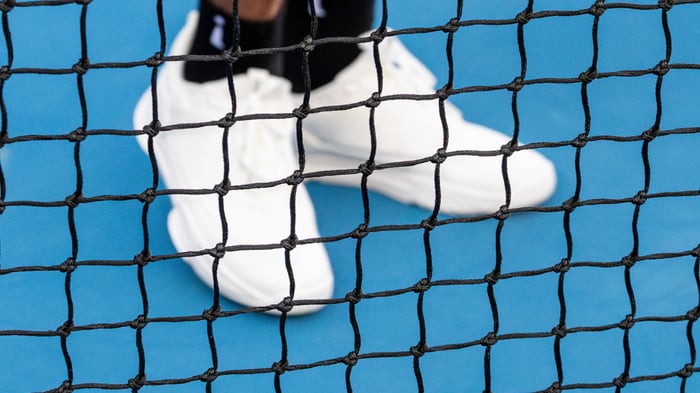 Pickleball shoes behind a net