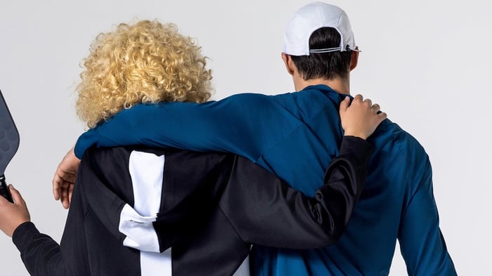 back shot of two pickleball players with their arms around each other