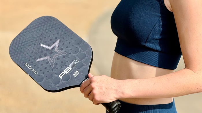 Pickleball player holding a pickleball paddle