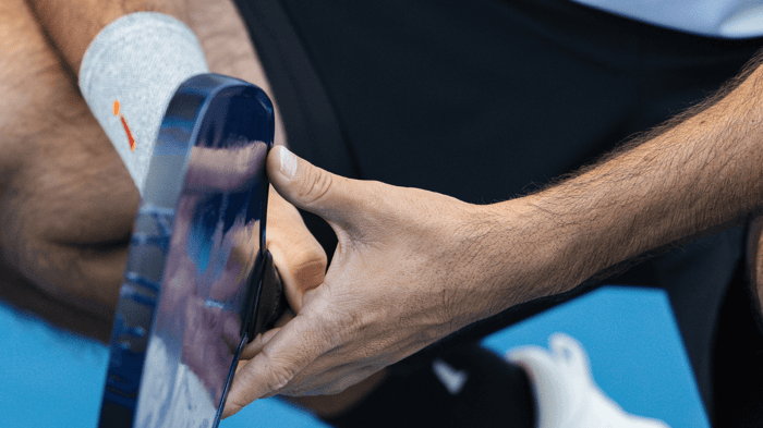 Pickleball player crouched on a court