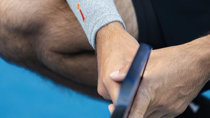 Close up shot of man crouched down holding a pickleball racket