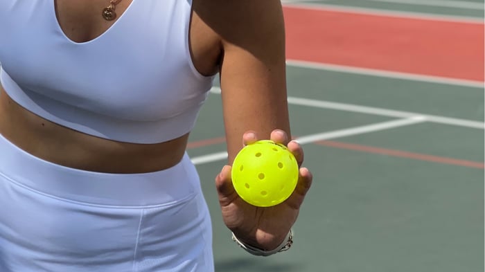 Player holding a pickleball