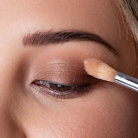 Model eye with eye shadow brush