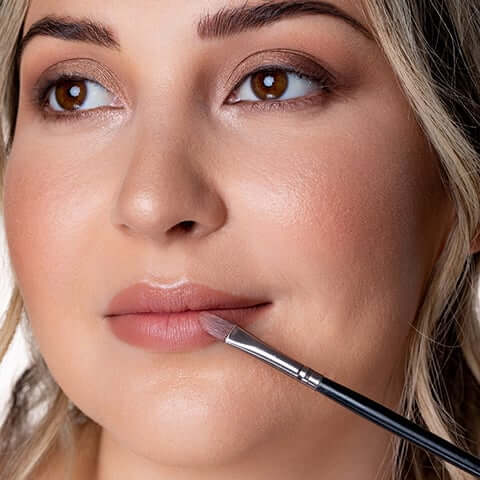MAC lipstick being applied to model's lip. 