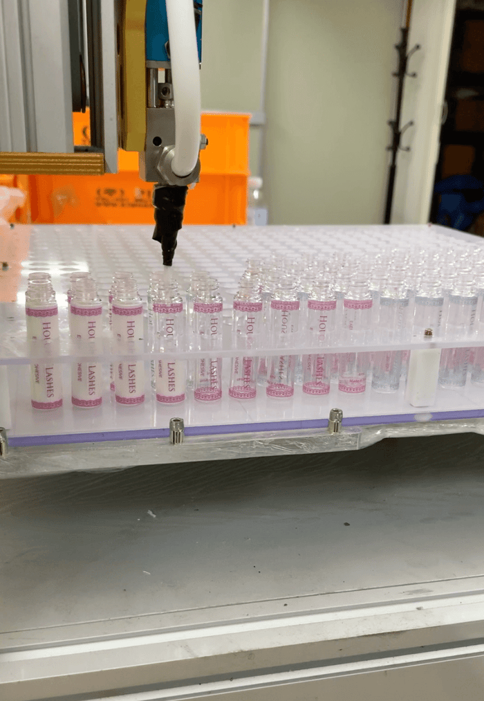 latex-free white lash glue being filled in the factory
