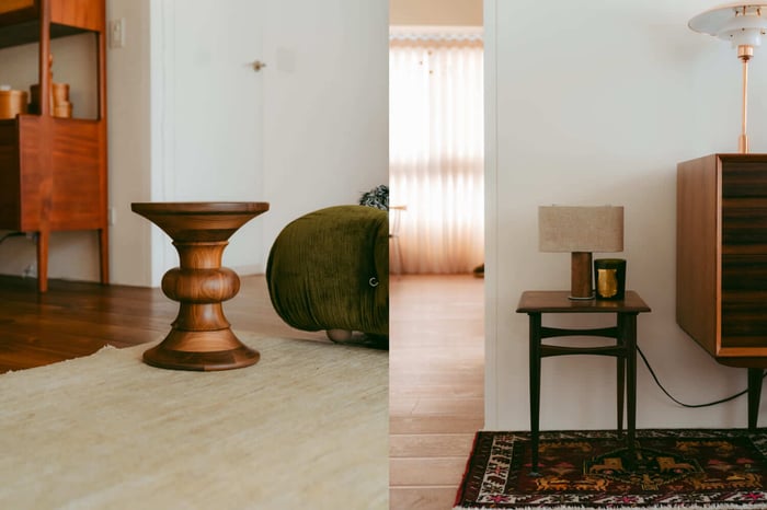 空間中經典的 Eames Stool b 胡桃木椅凳與簡約側邊桌,展現洗鍊的木質層次感。