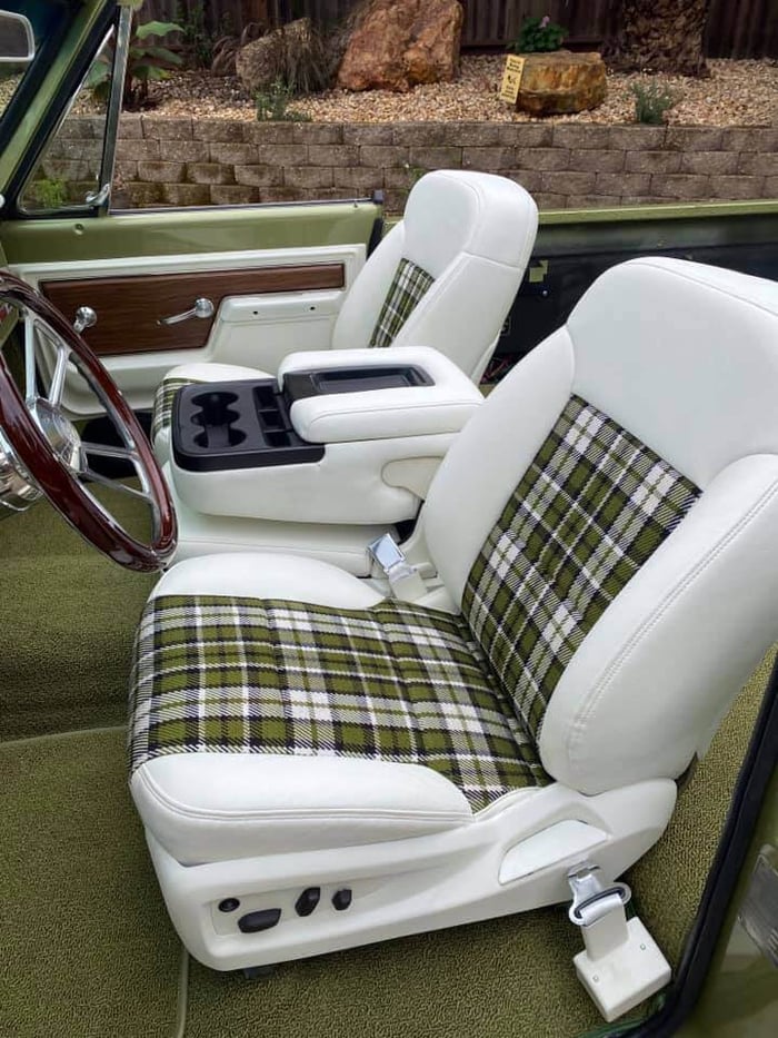 View inside the cabin showing custom upholstery and restored dash layout.