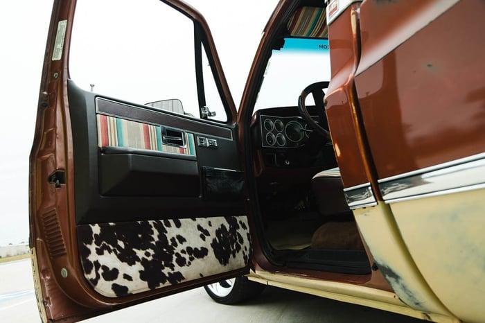 Door panels upholstered in custom fabric with tweeters flush-mounted.